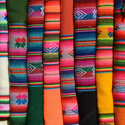 Row of folded colorful textiles.