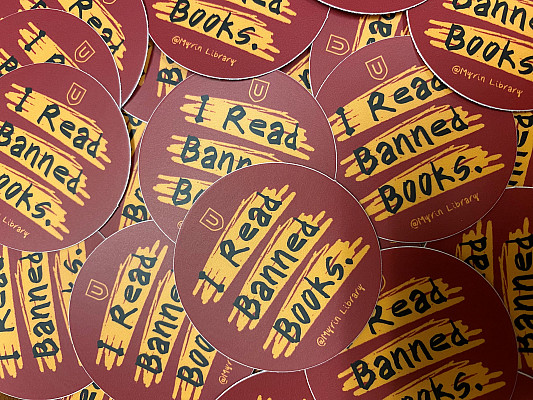 Round stickers stating, I Read Banned Books.