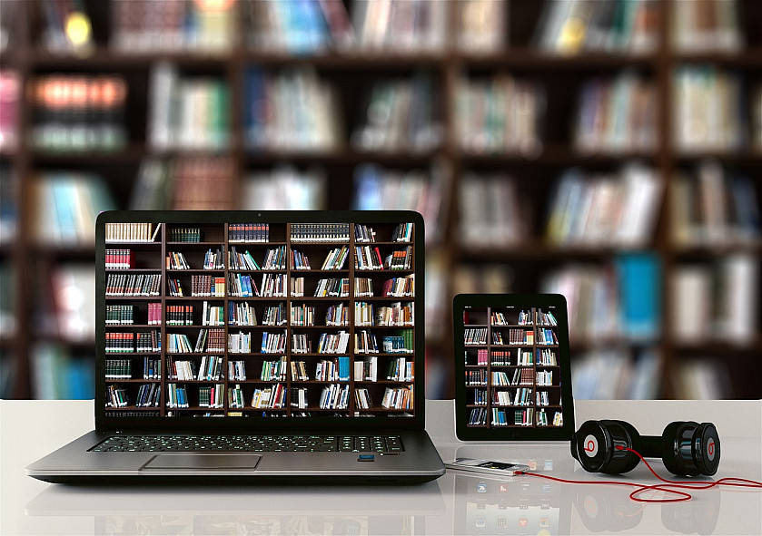Computer depicting books in a library