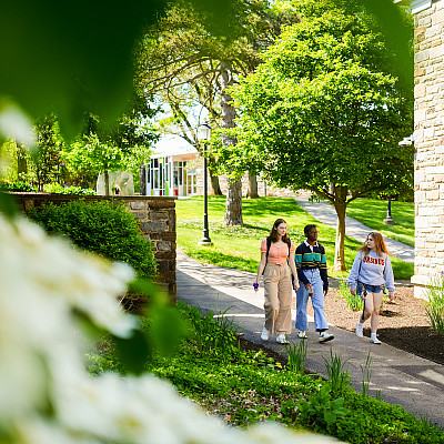 Students walking through campus on a spring afternoon.