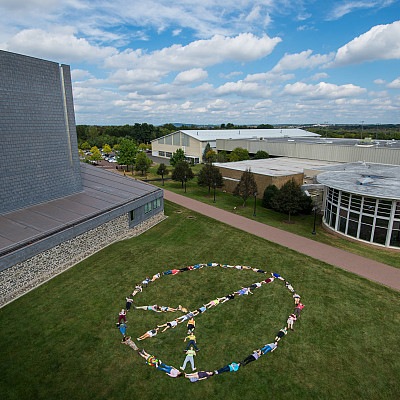 Overhead peace sign shot - a promotional ad for a theater performance.