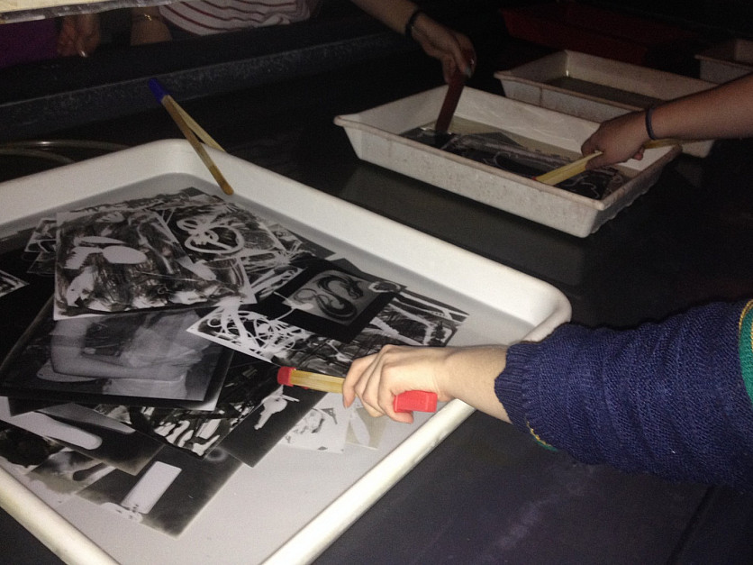 Students developing their photographs in the darkroom.