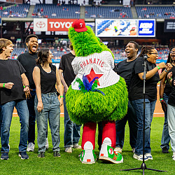 The Philly Phanatic interacts with Voices of Ursinus before singing National Anthem  at the Phillies 2024
