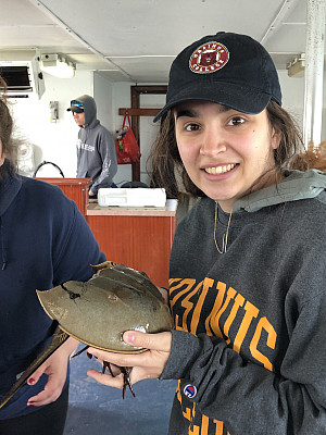 Student Nareen with horseshoe crab on sea cruise.