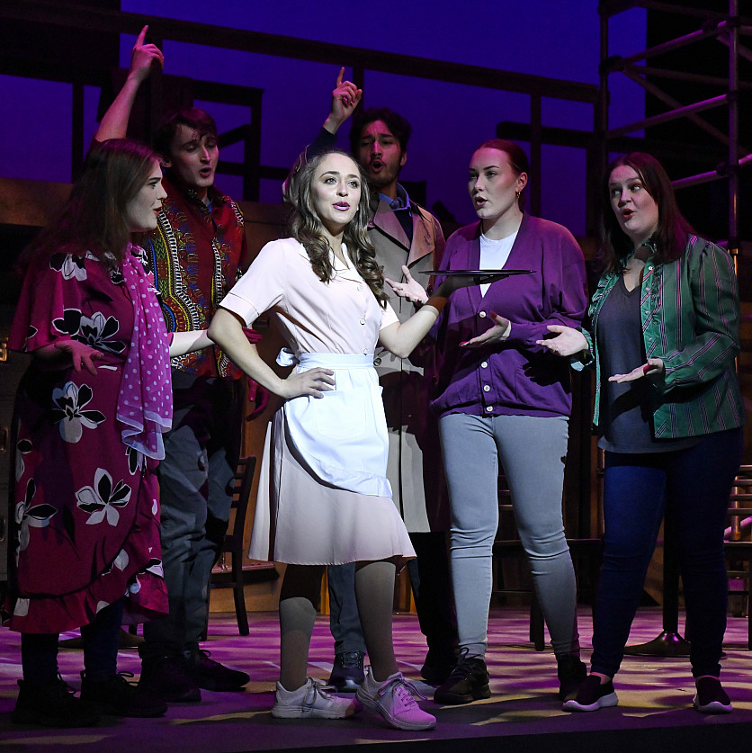 Group of theater majors performing on stage during a play.