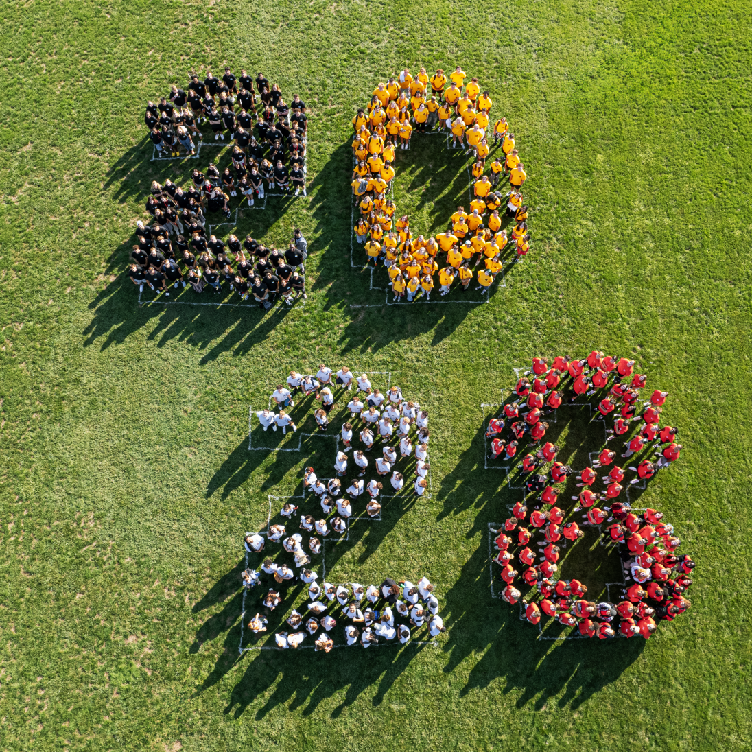 The Class of 2028 in formation on the Facilities Intramural Field for the class photo. August 23, 2024