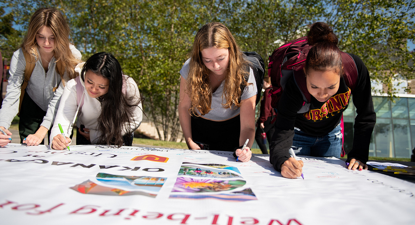 Students, faculty, and staff ceremoniously signed a banner signifying their own wellness commitment at the inauguration luncheon on Octob...