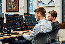 Nick Troha '24 (left) and Evan Coffey '24 work on the new Bloomberg terminals in the Myrin Library.