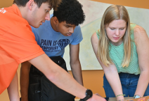 Charles Ohanian, Nihal Kumar, and Margaret Cathcart work on a mathematical biology project as part of the REU program.