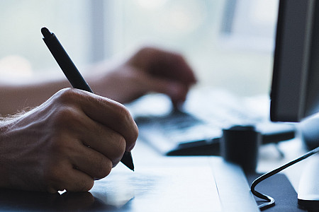 man hands drawing on graphic tablet with stylus. designer or digital artist at work
