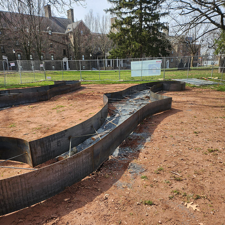 Steel molds on top of trenches dug in the earth.