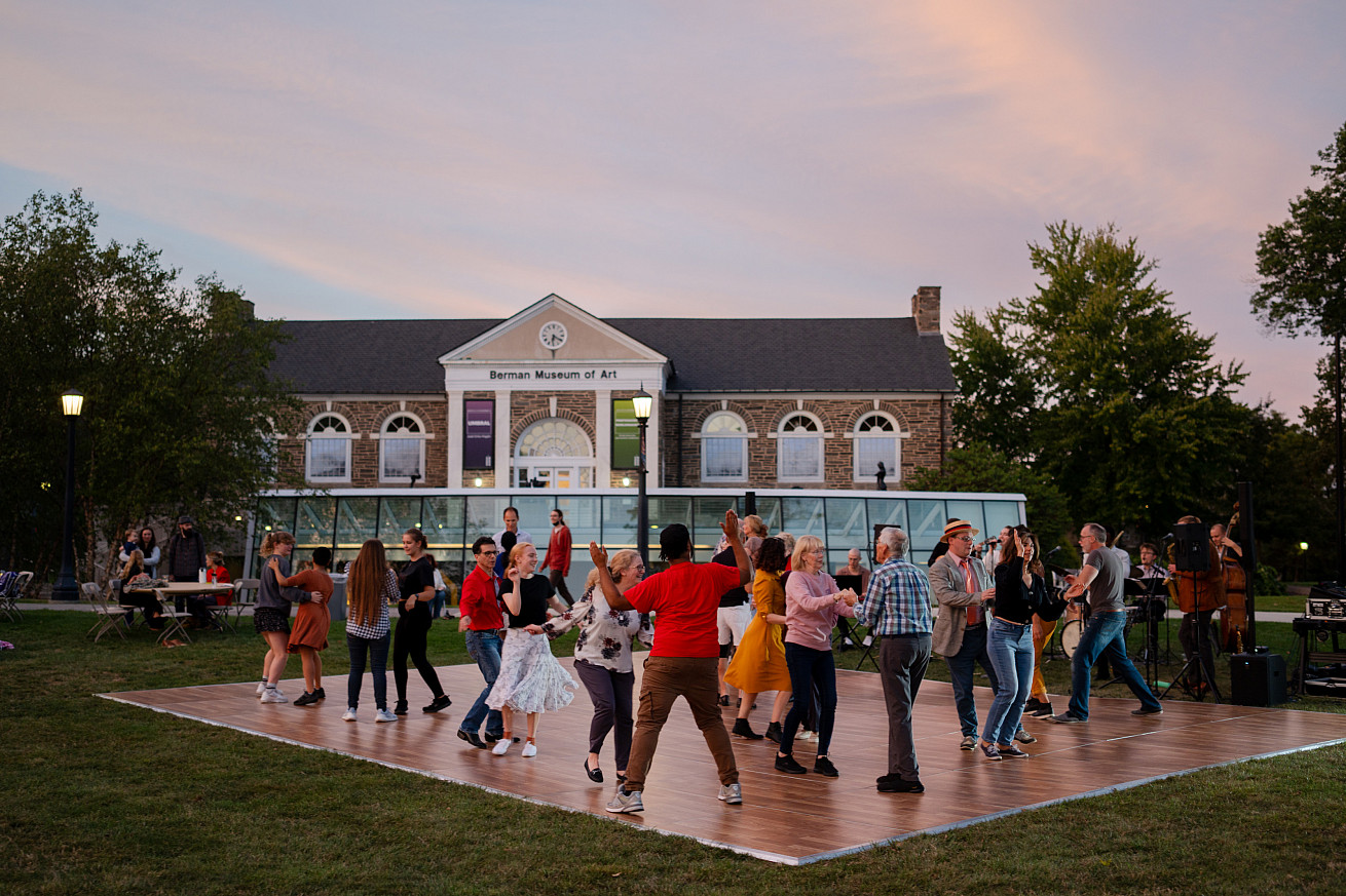 Members of the local community dance with Ursinus students, faculty, and staff in front of the Berman at the museum's 2023 Fall Swing Social.