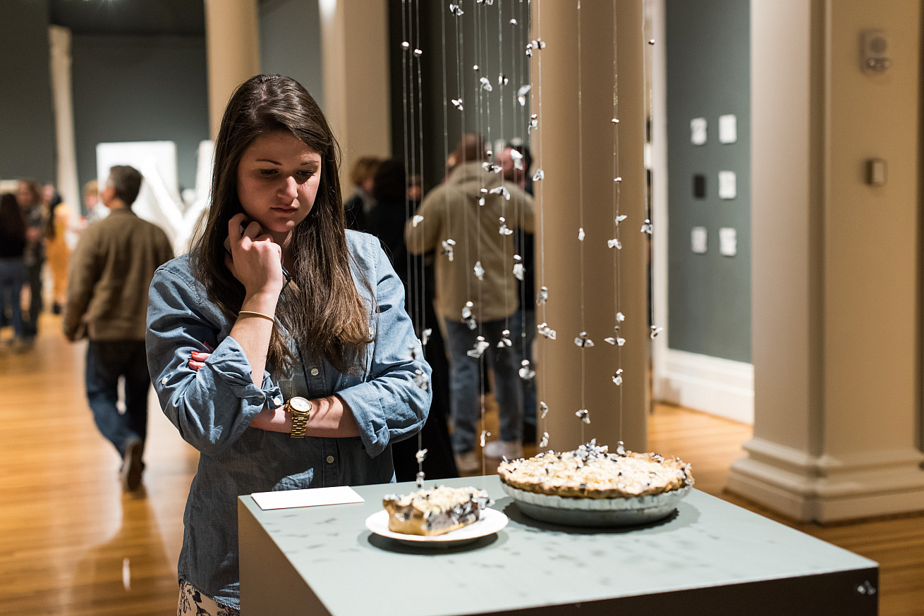 Woman admires sculpture at a Berman Opening Reception.