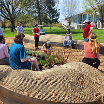 Syd Carpenter with BIO 334 students at the hügel site to prepare and organize the garden's plants.