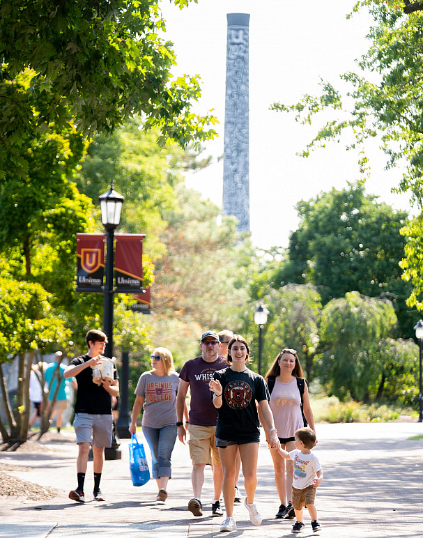 Ursinus student walks with their family on campus during Fall Family Weekend. Katie Merz's Li...
