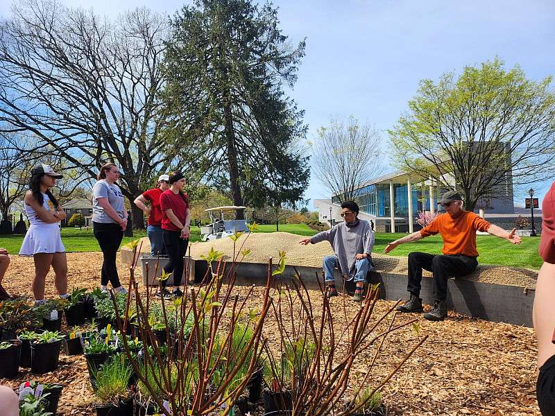 ENVS students help install plantings for the campus's new hugel garden. Compared to flat gardens, hügels improve drainage and water cons...