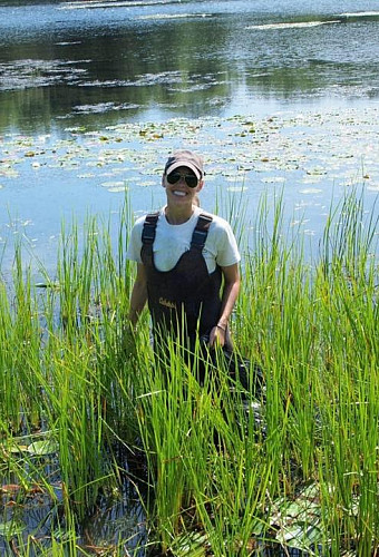 Jessie Kemper working to remove invasive species from our waterways.