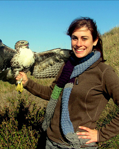 Photo of Regan Dohm holding a bird of prey
