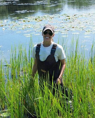 Jessie Kemper working to remove invasive species from our waterways.
