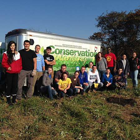 Group of students on a field experience with Conservation planting.