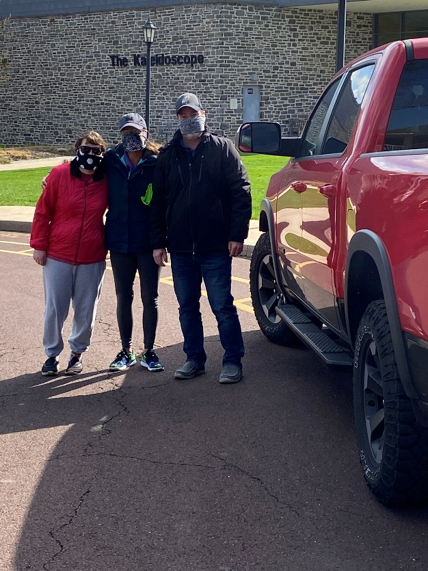 Tiffini and her parents picking up the 3D printers from UC