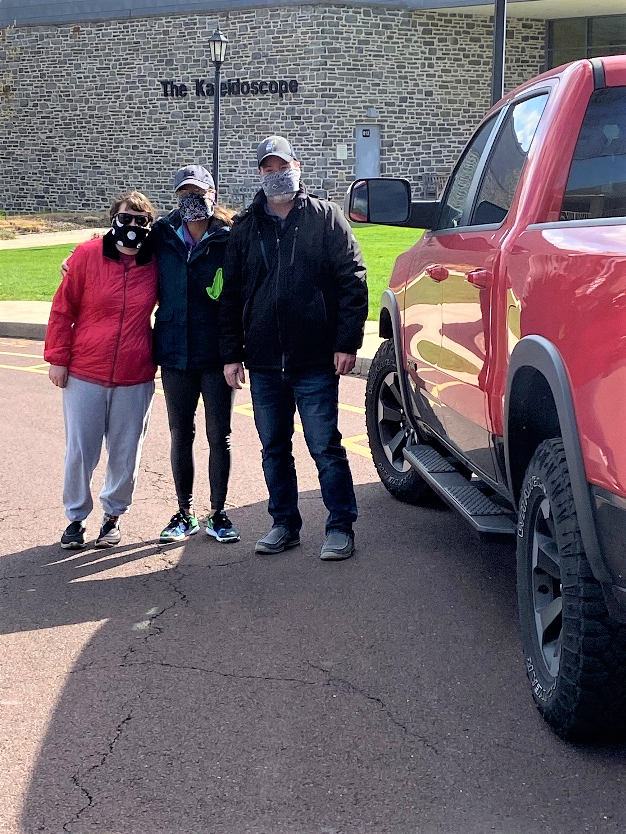 Tiffini and her parents picking up the 3D printers from UC