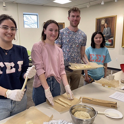 German Easter Bread Making Spring 24 Fulbright TA, Josepha Pape, is holding the tray Modern Languages Dept Modern Languages Dept