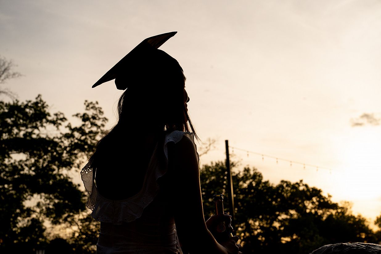 Student in shadow with cap and gown