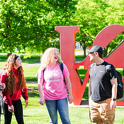 Candid photo of students conversating and laughing together outside at Ursinus College