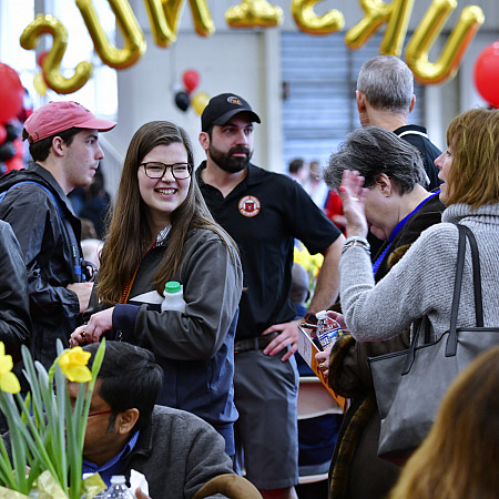 Group of parents and newly admitted students conversating at the Admitted Students Day event.