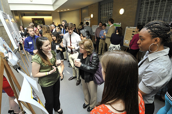 Students describe their scholarly work during CoSA 2014.
