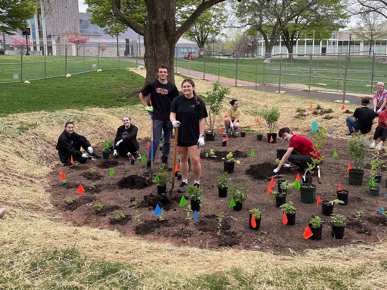 Students planting the rain garden in spring 2023